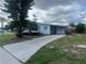 Charming single-story home with an ample driveway and mature landscaping at 230 Waterway Cir Ne, Port Charlotte, FL 33952