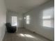 Neutral room with modern flooring, fresh white paint and a single accent chair at 230 Waterway Cir Ne, Port Charlotte, FL 33952