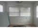Well-lit room features decorative brick walls, tiled floors, a mini split AC, and windows with blinds at 230 Waterway Cir Ne, Port Charlotte, FL 33952