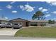 Single-story home with a well-manicured lawn and attached garage, ample driveway parking at 23269 Lehigh Ave, Port Charlotte, FL 33954