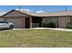 Cozy single-story home with an attached garage, screened porch and manicured lawn at 23269 Lehigh Ave, Port Charlotte, FL 33954