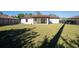 Large backyard featuring a screen lanai and dark metal fence at 2405 Mistleto Ln, North Port, FL 34286