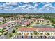 An aerial view captures the community's layout with ponds and green spaces, surrounded by residential homes at 25100 Sandhill Blvd # F-203, Punta Gorda, FL 33983