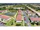 Drone shot of condo community with a pond and well-maintained landscaping at 25100 Sandhill Blvd # F-203, Punta Gorda, FL 33983