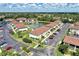 Aerial view of a condo community, featuring a pond and plenty of parking at 25100 Sandhill Blvd # F-203, Punta Gorda, FL 33983