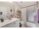 Bright bathroom with white cabinets, neutral paint, tile flooring, a bathtub and shower, and a large mirror at 25100 Sandhill Blvd # F-203, Punta Gorda, FL 33983