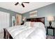 Comfortable main bedroom with ceiling fan, a large bed with white duvet, and bedside tables with lamps at 25100 Sandhill Blvd # F-203, Punta Gorda, FL 33983