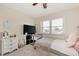 Cozy bedroom with television, plush carpet, and a window for natural light at 25100 Sandhill Blvd # F-203, Punta Gorda, FL 33983