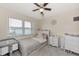 Cozy bedroom with carpet flooring, ceiling fan, and a window for natural light at 25100 Sandhill Blvd # F-203, Punta Gorda, FL 33983