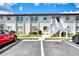 Exterior view of condominium unit with exterior staircase and parking at 25100 Sandhill Blvd # F-203, Punta Gorda, FL 33983