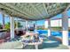 Outdoor grilling area under a covered patio, featuring stone bench seating and barbecue grills at 25100 Sandhill Blvd # F-203, Punta Gorda, FL 33983