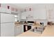 Functional kitchen with essential appliances, light countertops and white cabinets for storage at 25100 Sandhill Blvd # F-203, Punta Gorda, FL 33983