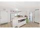 Charming kitchen featuring white cabinetry, bright countertops, and a door to the outside at 25100 Sandhill Blvd # F-203, Punta Gorda, FL 33983
