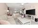 Open concept living room and kitchen with ceiling fan, tile flooring, neutral walls, and lots of natural light at 25100 Sandhill Blvd # F-203, Punta Gorda, FL 33983