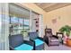 Relaxing screened patio with outdoor seating, a view to the exterior, and great light at 25100 Sandhill Blvd # 203, Punta Gorda, FL 33983