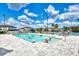 Community pool featuring ample seating and a refreshing escape on a sunny day with blue skies at 25100 Sandhill Blvd # F-203, Punta Gorda, FL 33983