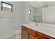 Clean bathroom featuring a single sink vanity, toilet, and glass-enclosed shower with decorative tile at 253 Marcheno Way, Nokomis, FL 34275