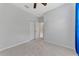 Spacious bedroom features neutral carpet, ceiling fan, and closet, with a doorway leading to another room at 253 Marcheno Way, Nokomis, FL 34275