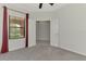Bright bedroom with a ceiling fan, neutral carpet, and adjoining room framed by white double doors at 253 Marcheno Way, Nokomis, FL 34275