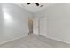 Bedroom with neutral carpet, ceiling fan, and closets, offering ample storage space at 253 Marcheno Way, Nokomis, FL 34275