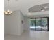 A view from the dining area, featuring a sliding glass door which leads to the outdoor pool at 253 Marcheno Way, Nokomis, FL 34275