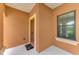 Interior view of a welcoming entryway with a neutral color palette and a glimpse of outdoor scenery at 253 Marcheno Way, Nokomis, FL 34275