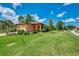 Inviting home exterior boasts well-maintained landscaping, including palms, and a vibrant green lawn at 253 Marcheno Way, Nokomis, FL 34275