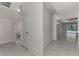 Clean hallway featuring tile flooring, with access to a bathroom and a view of the pool area at 253 Marcheno Way, Nokomis, FL 34275