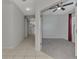 Open hallway view connecting to a bedroom with carpet and a ceiling fan, promoting an easy transition between spaces at 253 Marcheno Way, Nokomis, FL 34275