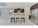 Kitchen features a spacious island with seating and updated stainless steel appliances at 253 Marcheno Way, Nokomis, FL 34275