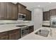 Modern kitchen has stainless steel appliances and plenty of cabinet space for storage at 253 Marcheno Way, Nokomis, FL 34275