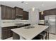 This open kitchen features granite countertops, tiled backsplash, and stainless steel appliances at 253 Marcheno Way, Nokomis, FL 34275