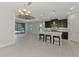 Bright kitchen boasts stainless appliances, breakfast bar with seating, and modern lighting at 253 Marcheno Way, Nokomis, FL 34275