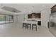 Bright kitchen features a large island with seating and views of the outdoor pool area at 253 Marcheno Way, Nokomis, FL 34275