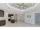 Open kitchen with dark wood cabinets, breakfast bar, and view to the living area at 253 Marcheno Way, Nokomis, FL 34275