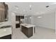 Updated kitchen features a center island with breakfast bar and stainless steel appliances at 253 Marcheno Way, Nokomis, FL 34275