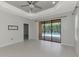 Spacious living room with tile flooring and sliding glass doors leading to the pool area at 253 Marcheno Way, Nokomis, FL 34275