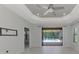 Bright living area with views of the pool and lanai through sliding glass doors at 253 Marcheno Way, Nokomis, FL 34275