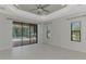 Open living room features tile flooring, neutral paint, and views of the pool at 253 Marcheno Way, Nokomis, FL 34275