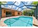 Beautiful sparkling pool inside a screened lanai with a tiled patio deck at 253 Marcheno Way, Nokomis, FL 34275