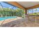 Screened lanai featuring a sparkling pool and outdoor kitchen with stainless steel grill at 253 Marcheno Way, Nokomis, FL 34275