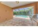 Relaxing covered patio with outdoor grill overlooking sparkling screened-in pool at 253 Marcheno Way, Nokomis, FL 34275