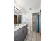 Well-lit bathroom featuring a modern vanity and a walk-in shower with grab bar at 25449 Doredo Dr, Punta Gorda, FL 33955