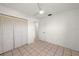 Neutral toned bedroom offers ample closet space and tile flooring at 25449 Doredo Dr, Punta Gorda, FL 33955