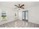 Bright bedroom with tile floors, natural light, and backyard view at 25449 Doredo Dr, Punta Gorda, FL 33955