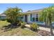 Inviting front entrance with decorative security door, complemented by colorful landscaping and charming details at 25449 Doredo Dr, Punta Gorda, FL 33955