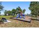 Colorful playground with slides, climbing structures, and swings, perfect for outdoor fun and recreation at 25449 Doredo Dr, Punta Gorda, FL 33955