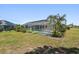 Screened-in pool surrounded by lush landscaping and a well-manicured lawn at 25449 Doredo Dr, Punta Gorda, FL 33955