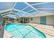 Inviting screened-in pool area with a built-in waterfall feature and covered patio for relaxation at 25449 Doredo Dr, Punta Gorda, FL 33955