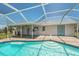 Beautiful pool with a screened enclosure, featuring a covered patio and outdoor entertainment space at 25449 Doredo Dr, Punta Gorda, FL 33955